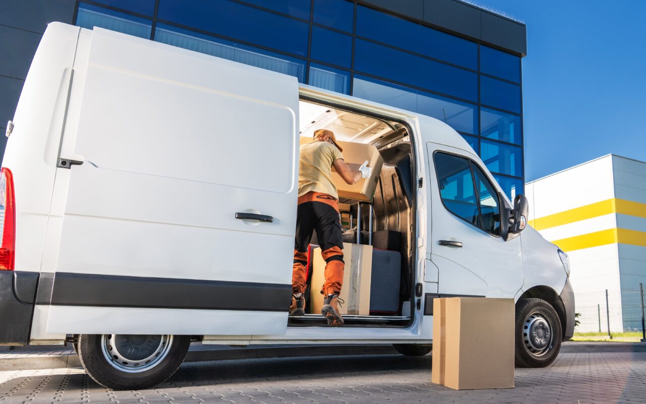 Delivery driver emptying a delivery van