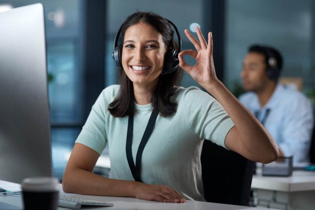 Support-Agent-Worker-Smiling-and-performing-an-okay-gesture